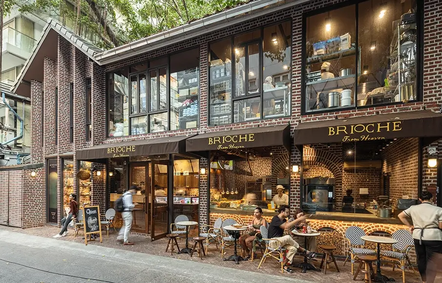 An inviting independent café shopfront with a clear A-board and attractive window display